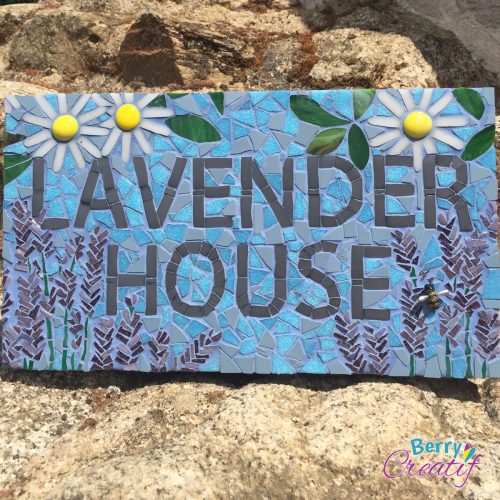 mosaic sign saying Lavender House with blue background and flowers