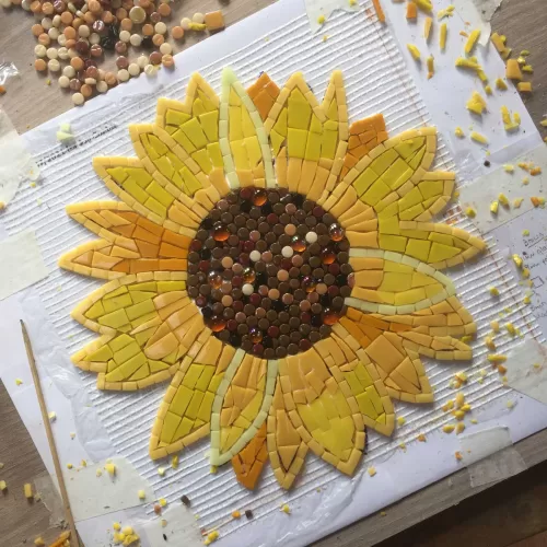 mosaic sunflower, all mosaic tiles are finished and some small snippets are showing around the edge of the item