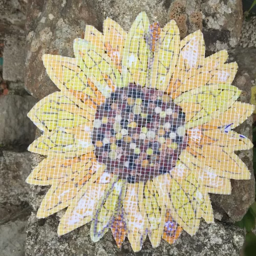 shows reverse of the mosaic sunflower. the mesh is visible, this is where the silicone glue will be applied