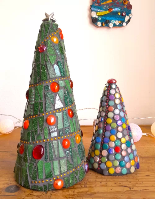 handmade mosaic christmas trees sitting on wooden furniture